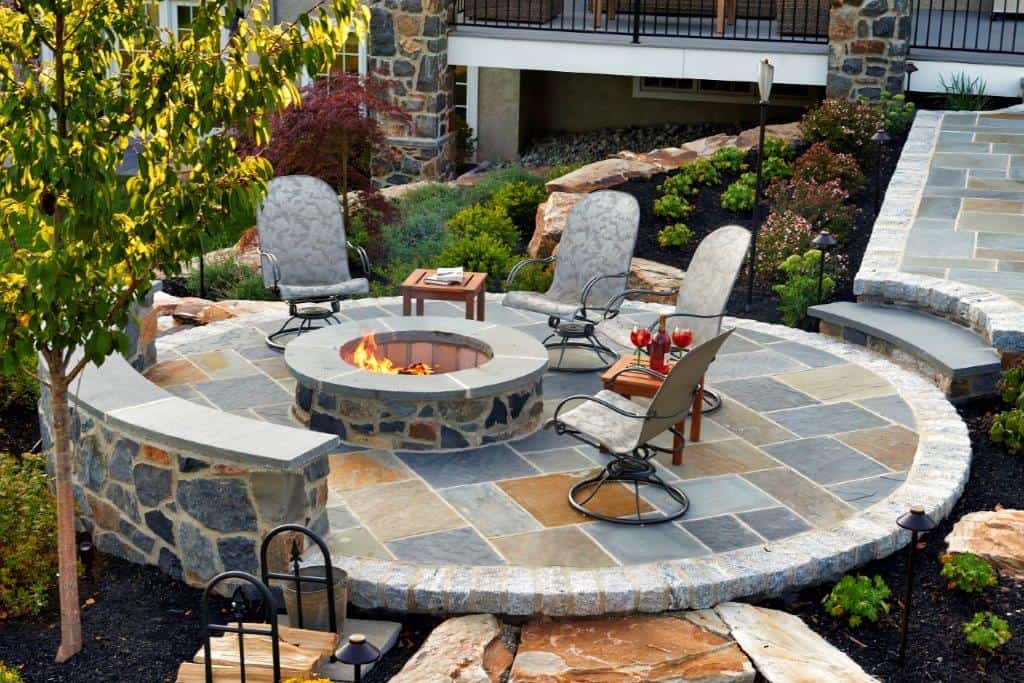 Round Slate Patio with stone firepit and stone walls MILLER - artisan masonry